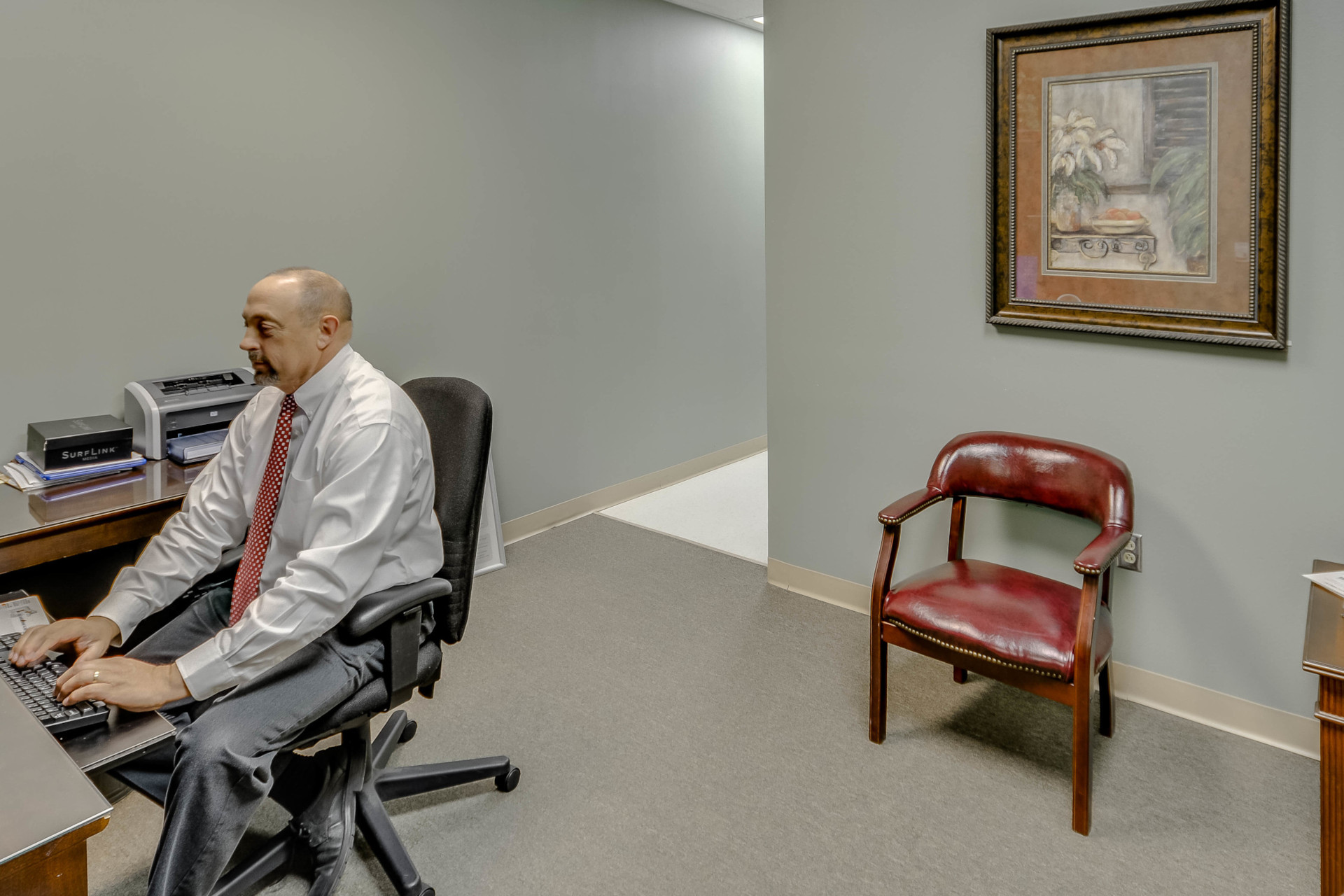 Office at Audible Hearing Centers with man working at keyboard